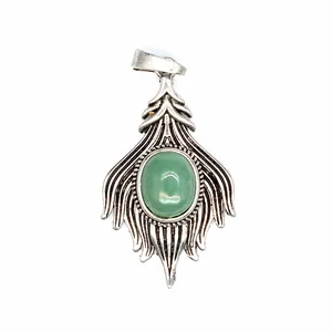 Detailed macro view of a vintage silver pendant featuring an oval green agate stone