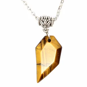 Detailed macro view of a natural tiger's eye stone pendant on a silver necklace chain