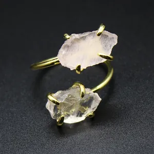 Macro view of raw rose quartz stones on a gold adjustable open ring