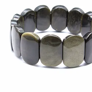 Close-up of polished 11x18mm oval natural stone beads on a stretch bracelet.