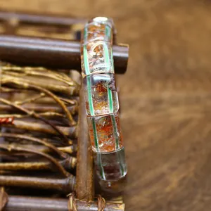 Close-up view of natural green phantom and yellow glue flower crystal hand plate