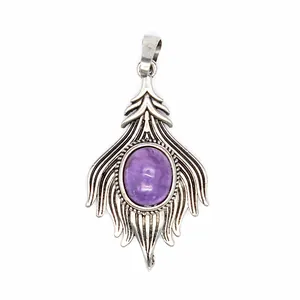 Detailed view of a vintage silver feather pendant with a purple oval amethyst stone