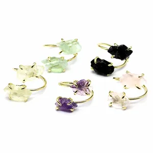 Collection of adjustable gold-plated rings with various raw natural gemstones