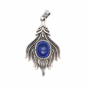 Close-up of vintage silver pendant with oval blue lapis lazuli stone inlay