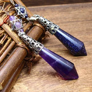Close-up of amethyst and blue goldstone hexagonal crystal pendulums with star charms