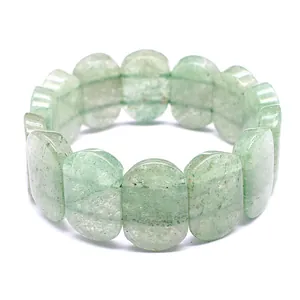 Detailed macro view of natural green stone oval bead bracelet with smooth polished finish