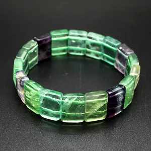 Detail of natural colorful fluorite square bead bracelet with green and purple stones.