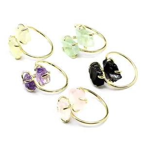 Detailed view of adjustable raw natural stone rings in various crystal types and colors