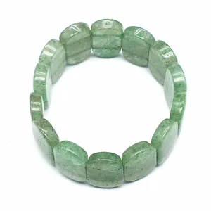 Detailed macro view of 11x18mm polished green natural stone beads on a stretch bracelet.