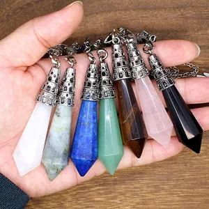 Various natural hexagonal crystal pendulum pendants featuring intricate decorative metal caps
