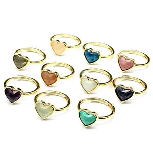 Detailed view of colorful heart-shaped faceted natural stone adjustable gold rings