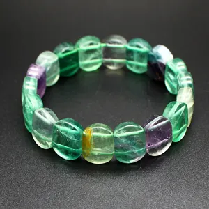 Detailed close-up of natural colorful fluorite beaded bracelet on black background