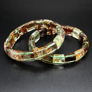 Detailed view of natural green phantom and yellow gum flower quartz crystal bracelets
