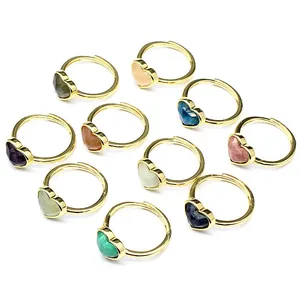 Collection of heart-shaped faceted natural gemstone rings with adjustable gold bands