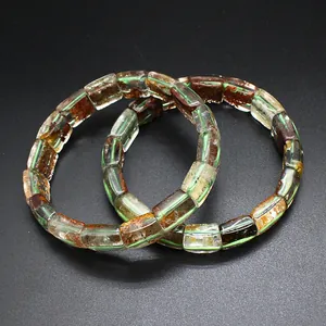 Detail view of natural green ghost and yellow gelato quartz hand plate bracelets.