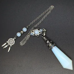 Detailed view of white opalite crystal prism pendulum with dreamcatcher and star charms