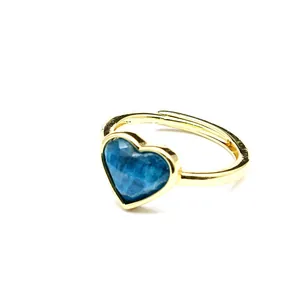 Close-up of the heart-shaped blue crystal gemstone on this elegant gold-plated open ring
