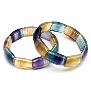 Detailed macro shot of natural multicolored fluorite crystal bracelets on white background