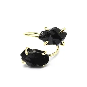Detailed view of adjustable gold-plated ring with two raw black natural gemstones