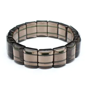 Detail shot showing the texture of dark striped Saffordite tektite stone bracelet.