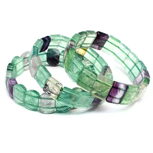 Close-up detail of natural colorful square fluorite gemstone beads with purple and green tones