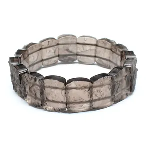 Detailed view of semi-transparent brown tektite stone bracelet with textured finish.