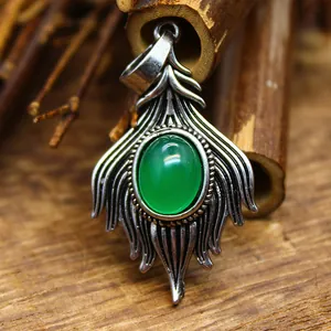 Macro detail of vintage ethnic style pendant necklace with an oval green agate stone