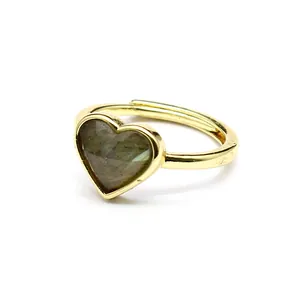 Detail close-up of heart-shaped faceted labradorite on adjustable gold ring band.