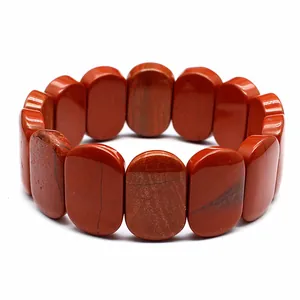 Macro view of a natural red jasper bracelet featuring polished 11x18mm oval beads
