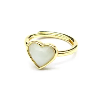 Close-up detail of a gold adjustable ring featuring a faceted heart-shaped stone
