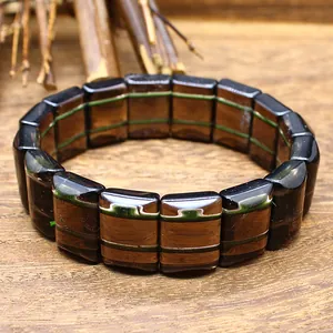 Close-up of natural tektite meteorite bracelet with unique dark brown banded texture