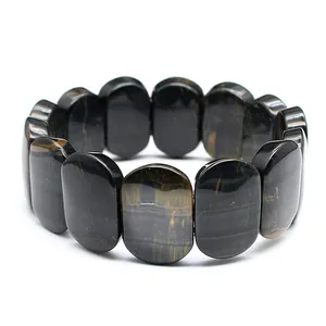 Detailed macro view of polished oval blue tiger eye stone beads on a stretch bracelet