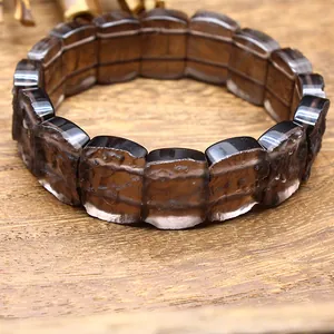 Close-up macro view of textured dark brown Arizona Siriusite glass meteorite bracelet