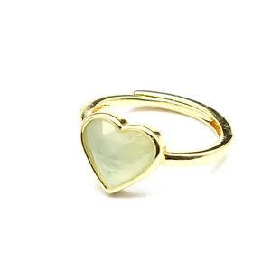 Detail view of heart-shaped faceted light green natural stone on adjustable gold ring