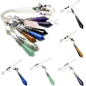Detailed close-up showing various hexagonal crystal prism pendulum pendants with charms