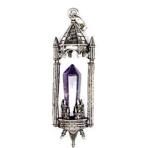 Detailed shot of a vintage medieval castle pendant with a purple crystal pillar