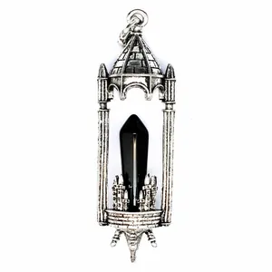 Detailed macro view of a gothic antique silver castle pendant with a sleek black crystal point