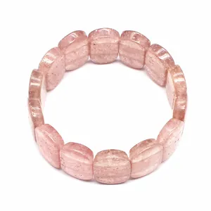 Detailed macro view of polished natural pink strawberry crystal stone plates on elastic bracelet