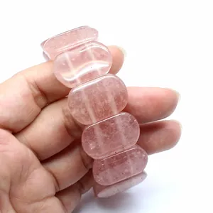 Detailed close-up of natural strawberry quartz crystal bracelet with 11x18mm oval stones