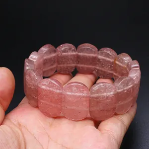 Detailed view of a natural strawberry quartz hand row bracelet with smooth oval beads.