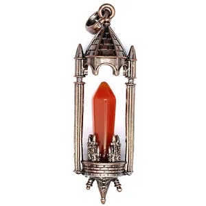 Macro detail of a vintage medieval castle pendant with an orange crystal pillar