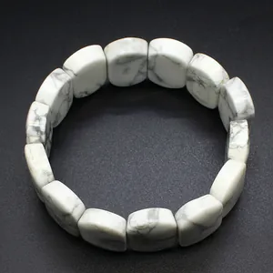 Detailed view of polished white howlite stone bracelet featuring natural grey marble texture
