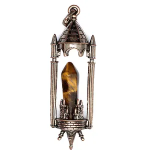 Detailed view of a vintage bronze castle pendant with a tiger's eye crystal pillar