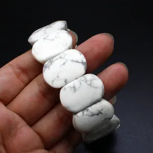 Detailed close-up of white natural stone oval beads on a comfortable stretch bracelet