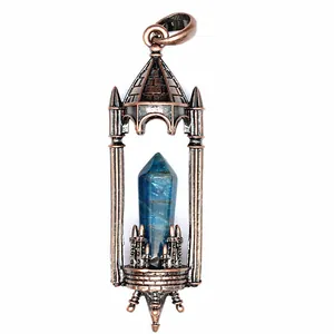 Detailed macro view of a vintage bronze castle pendant featuring a blue hexagonal crystal pillar