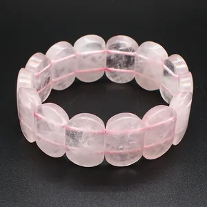Detailed macro view of smooth pink rose quartz oval beads on a flexible stretch bracelet