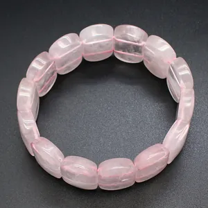 Macro view of natural rose quartz bracelet featuring smooth oval polished stone beads