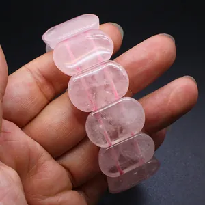 Close-up detail of natural translucent pink oval crystal beads on a stretch bracelet
