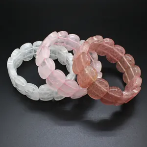 Close-up detail of smooth oval natural crystal beads in pink, red, and white hues.