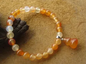 Détail macro d'un bracelet en agate rouge naturelle avec pendentif en calebasse